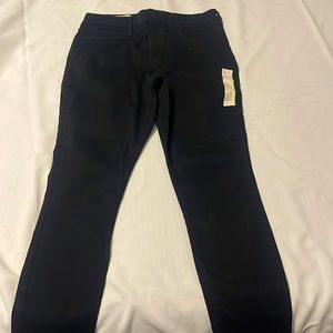 Black pants, high rise with back pockets .  Length is short